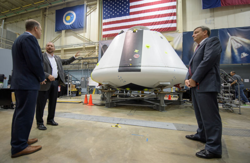 NASA Administrator Jim Bridenstine, left, was shown the Orion test crew capsule that will be used for the Ascent Abort-2 test. NASA's Jon Olansen, second from left, speaks as Orion Program Manager Mark Kirasich looks on.