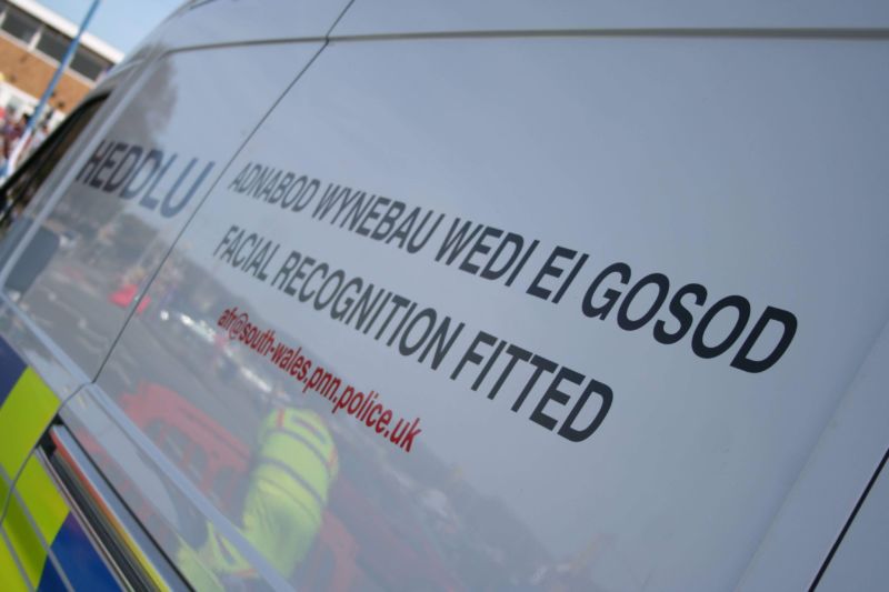Detail of a police van with word etched in both English and Welsh.