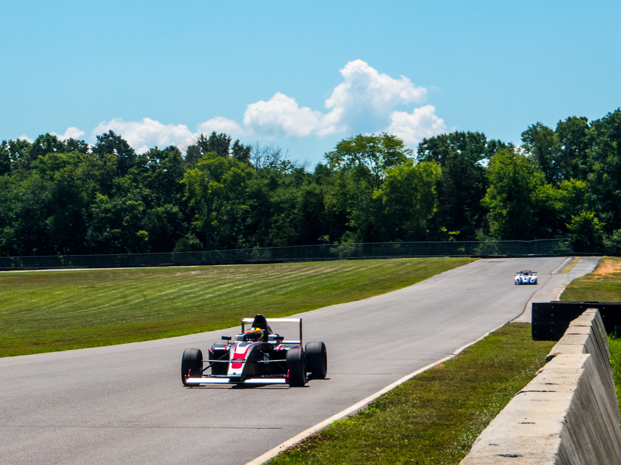 A Formula 4 car leads a Radical SR1 at Virginia International Raceway