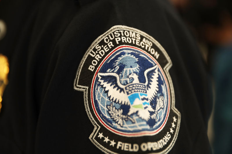 A patch is seen on the sleeve of a U.S. Customs and Border Protection officer as he uses facial recognition technology in his booth at Miami International Airport to screen a traveler entering the United States on February 27, 2018 in Miami, Florida. 