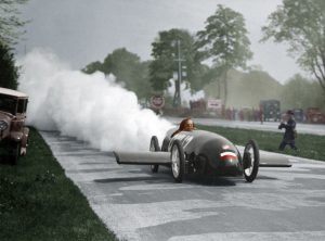 Fritz von Opel driving the rocket-powered car Opel RAK 2 at the motor racing circuit AVUS