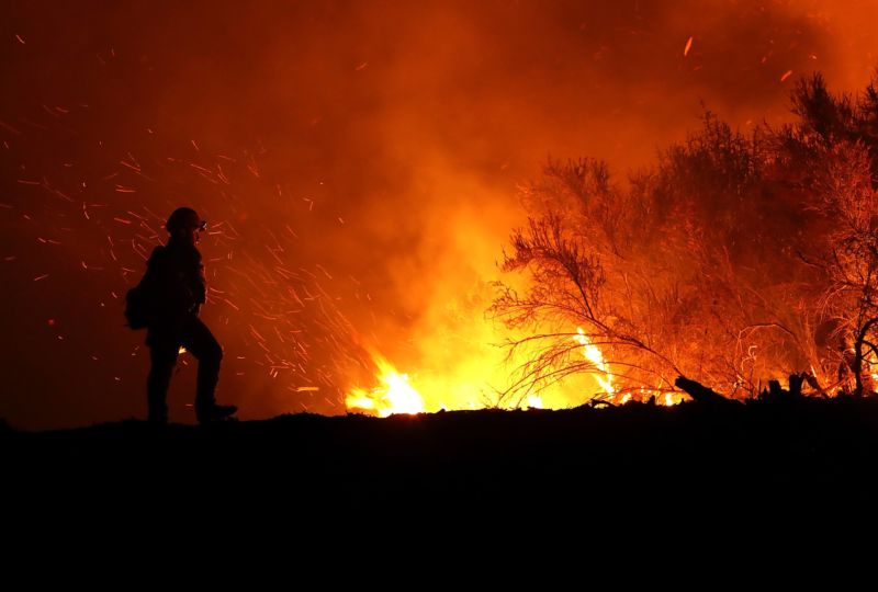 A firefighter at the scene of a wildfire.