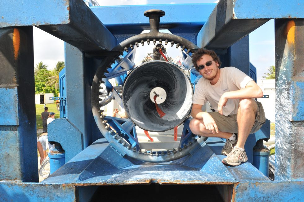 Zach Dunn with the Merlin engine that powered the successful fourth flight of the Falcon 1 rocket.