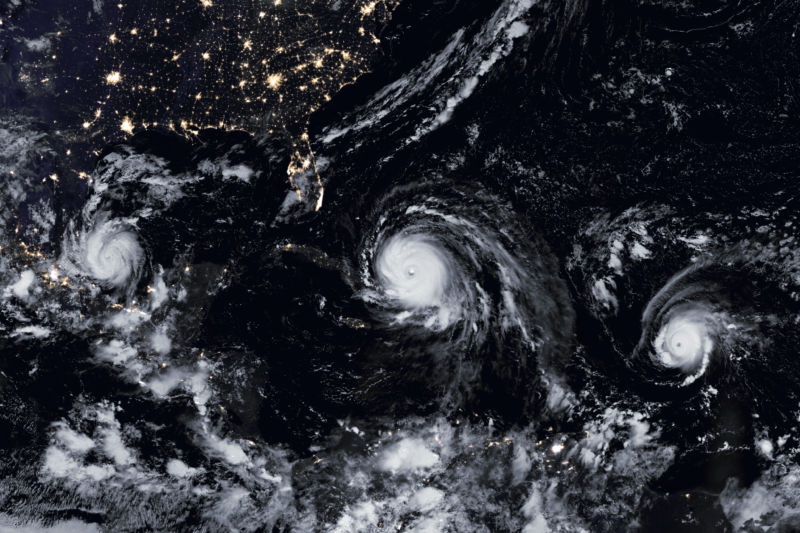 View of the outer space of three hurricanes crossing the ocean to the United States.