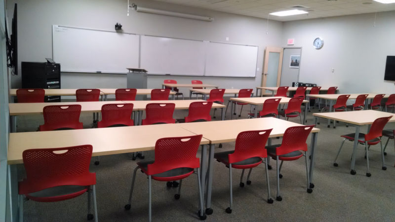 Empty classroom with whiteboards.