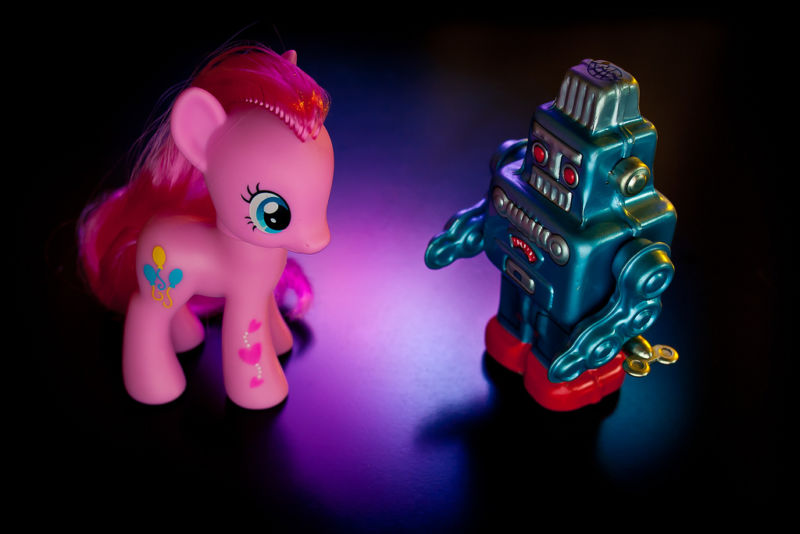 A toy robot confronts a My Little Pony.