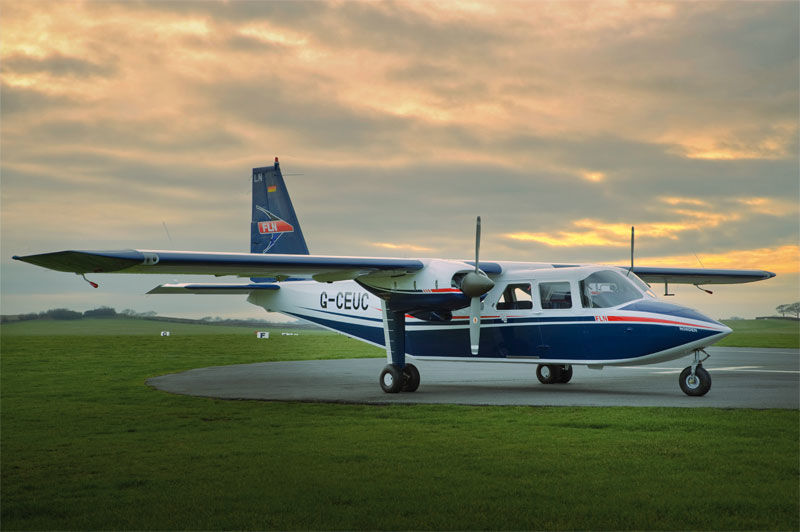 Eight-seater two-engine propellor plane on a runway.