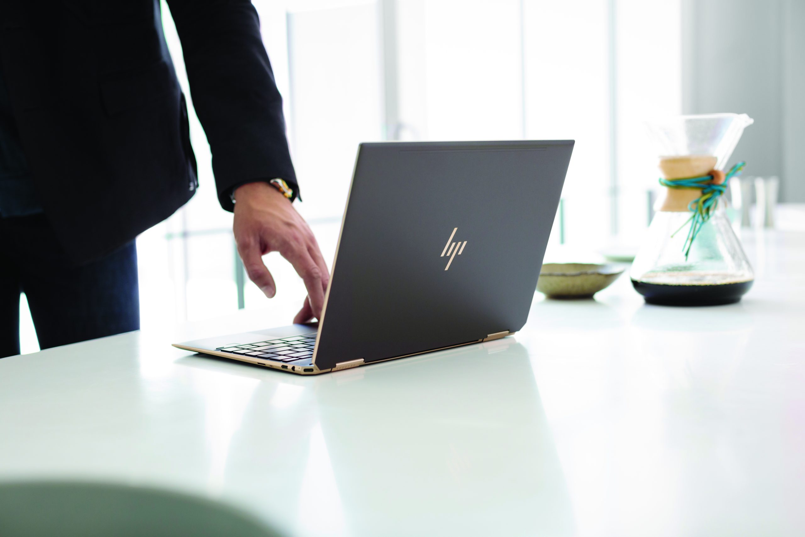 The 2018 HP Spectre x360 13 on a white table.
