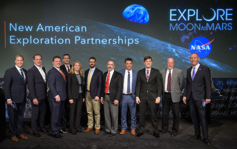 NASA Administrator Jim Bridenstine, left, and Associate Administrator Thomas Zurbuchen, right, are shown with the representatives of the nine US companies that are eligible to bid on NASA delivery services to the lunar surface.