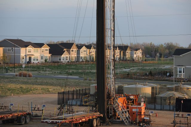 An oil derrick rises up in Erie City Park where maintenance is being done to the well on the site Thursday morning, April 23, 2015. 