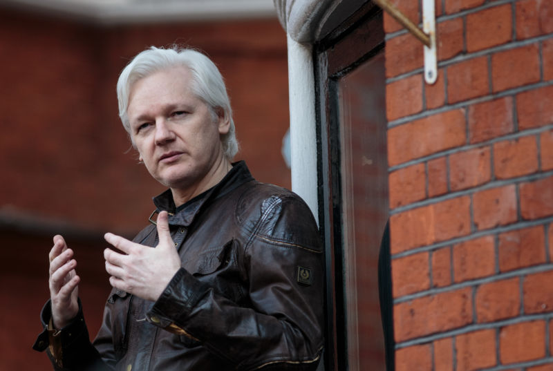 Julian Assange gesturing with his hands as he speaks to the media from the balcony of the Embassy of Ecuador on May 19, 2017 in London, England.