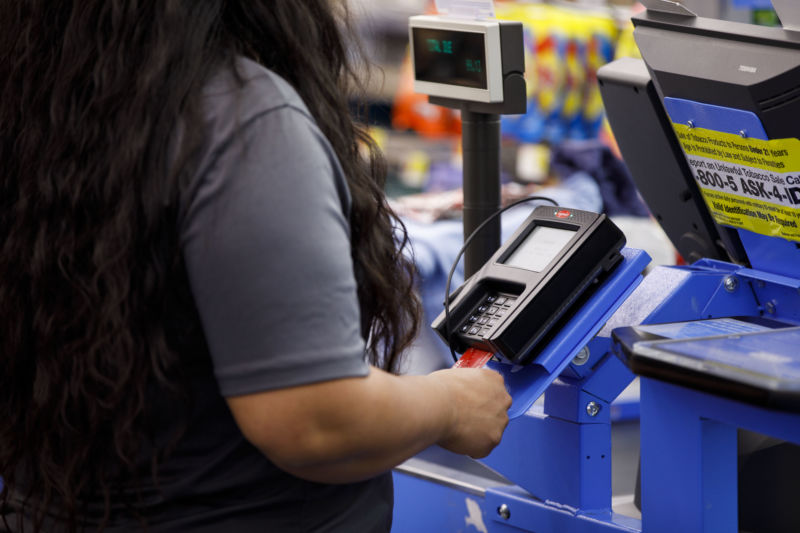 woman inserting a chip card into a terminal