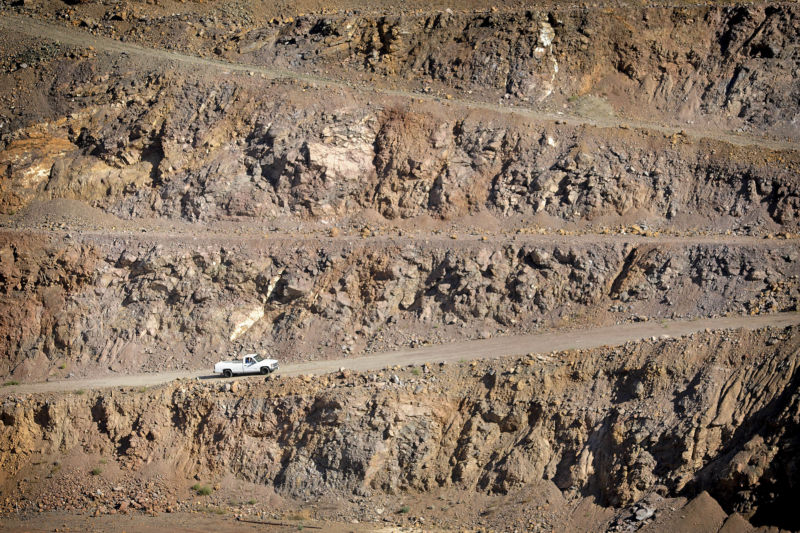 truck drives out of rare earth mineral mine