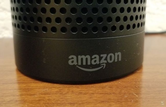 Close-up of the base of an Amazon Echo smart speaker using the Alexa service, with Amazon logo visible, on a light wooden surface, San Ramon, California, May 31, 2018.