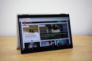 The 2018 HP Elitebook x360 2-in-1 sitting on a wooden table.