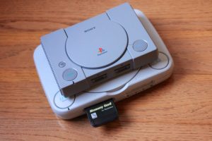 Two gaming consoles, one atop the other.