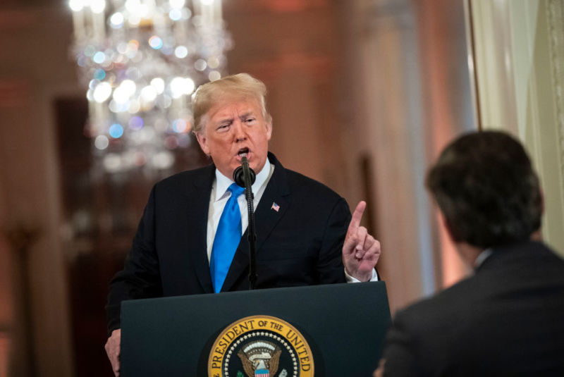 President Donald Trump at a press conference, pointing his finger and talking to CNN journalist Jim Acosta.