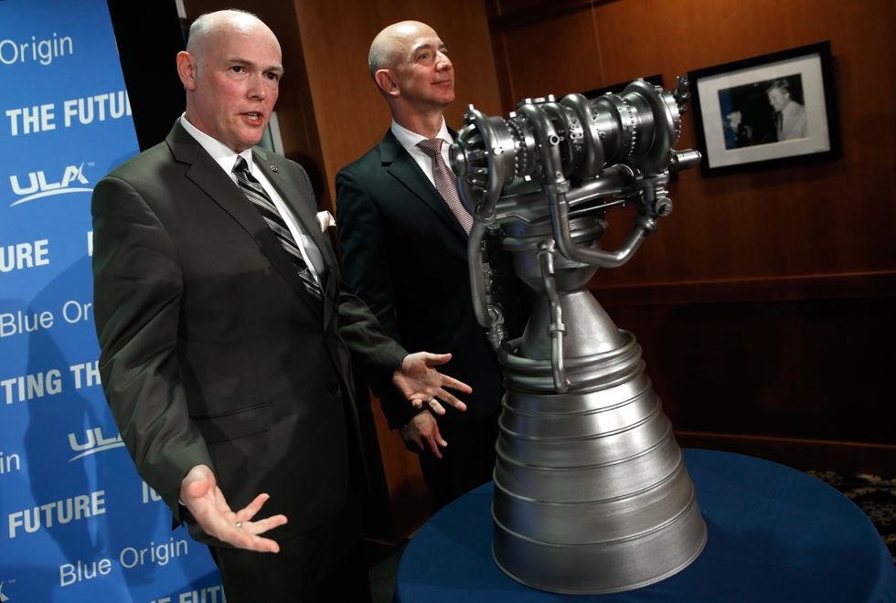 Jeff Bezos (right), the founder of Blue Origin and Amazon.com, and Tory Bruno, CEO of United Launch Alliance, display a small-scale version of the BE-4 rocket engine during a press conference in 2014.