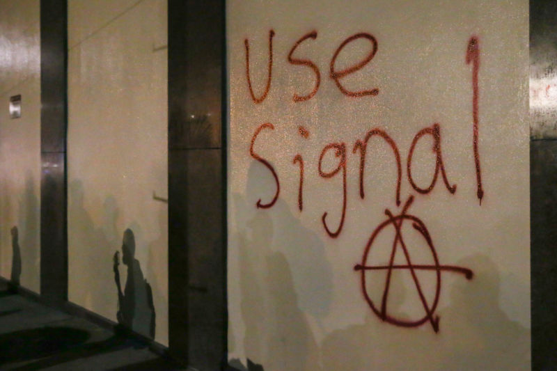Graffiti urging people to use Signal, a highly encrypted messaging app, is spray-painted on a wall during a protest on February 1, 2017 in Berkeley, California.