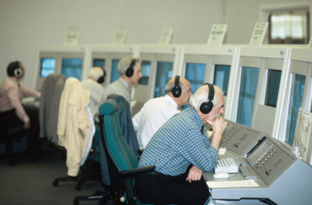 Air traffic controllers at the NATS London Area Control Centre LACC in Swanwick, UK. Heavily accented English over noisy communications channels is a real test of AI voice recognition.