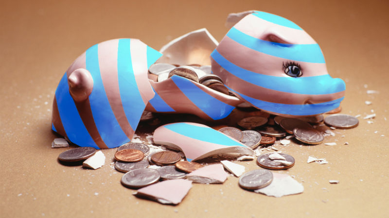 A broken piggy bank covered with AT&T's logo.
