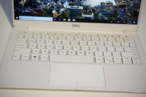 The new Dell XPS 13 laptop sitting on a white table.