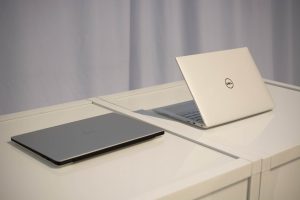 The new Dell XPS 13 laptop sitting on a white table.