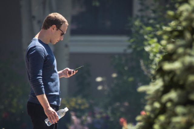 Facebook CEO Mark Zuckerberg checks his phone during the annual Allen &amp; Company Sun Valley Conference, July 13, 2018 in Sun Valley, Idaho. 