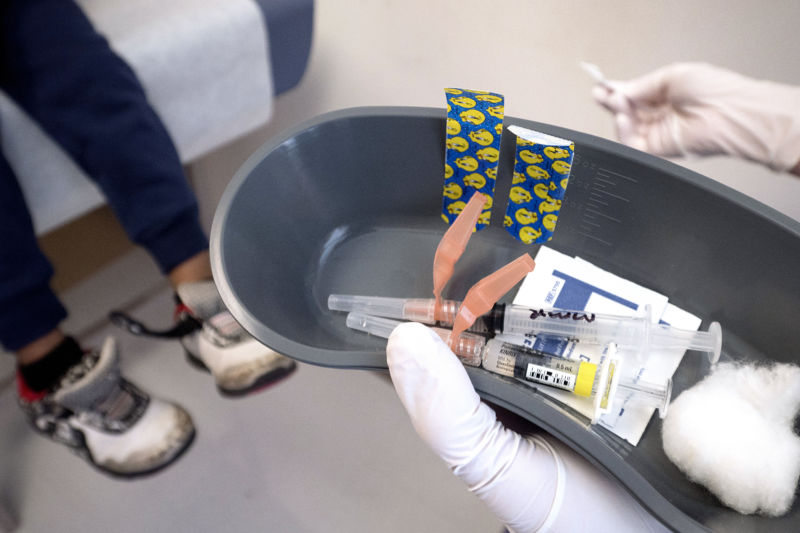 A nurse prepares to administer the measles, mumps, and rubella (MMR) vaccine as well as a vaccine used to help prevent the diseases of diphtheria, pertussis, tetanus, and polio at Children's Primary Care Clinic in Minneapolis, MN.