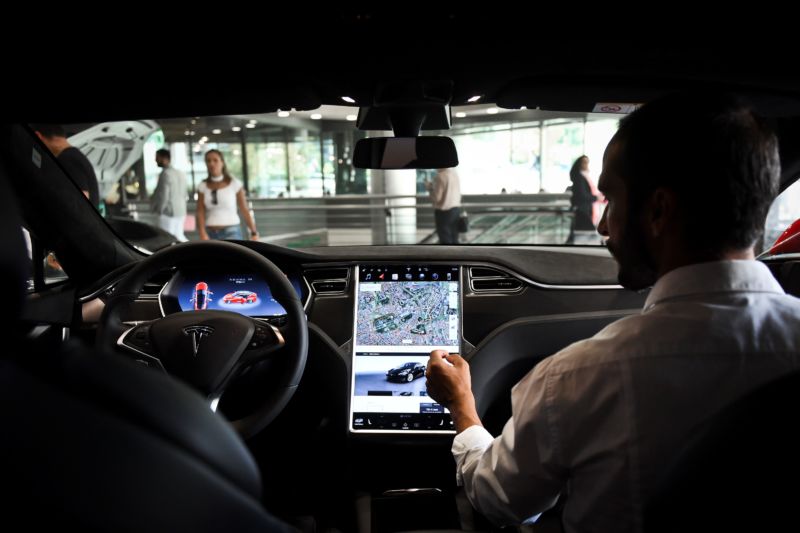 A seller shows the dashboard of the Tesla Model S car at the electric carmaker Tesla showroom of El Corte Ingles store in Lisbon, on September 1, 2017. 