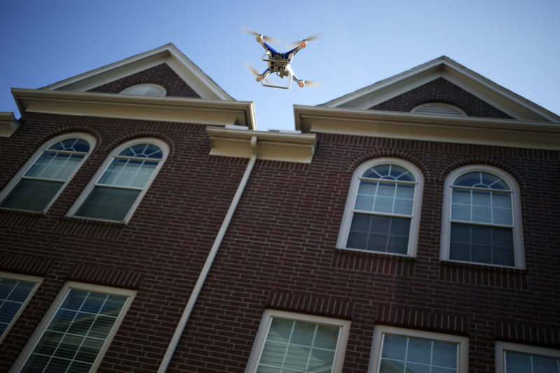 Unmanned aircraft being flown over large house.