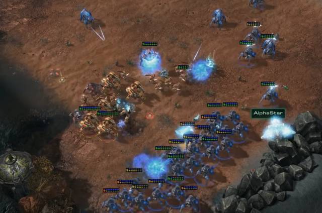 In this scene from Game 4 of the AlphaStar v. Komincz series, AlphaStar's Stalkers (blue) attack Komincz's Immortals, Archons, and Zealots (red) on three sides. AlphaStar's Stalkers ultimately won this battle and went on to destroy Komincz's base.