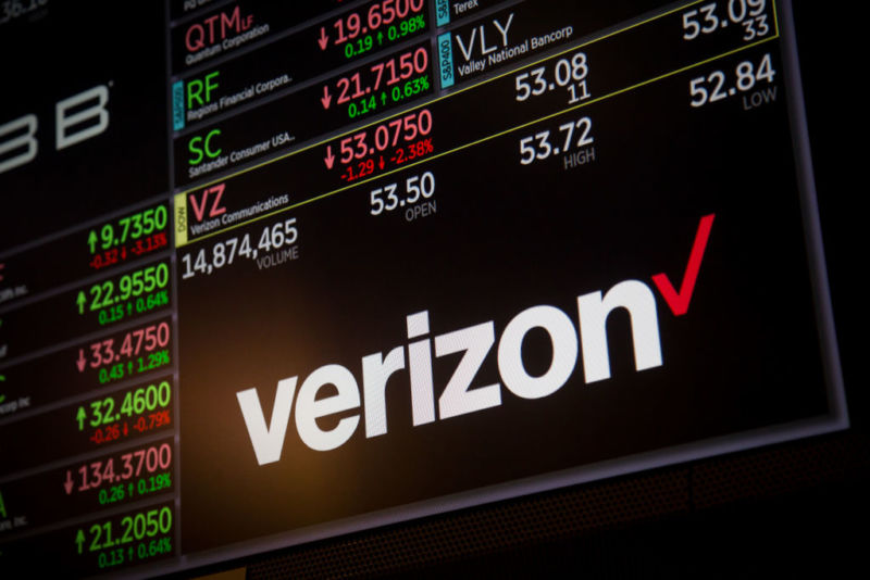   A Verizon logo shown along with stock prices on the New York Stock Exchange. 
