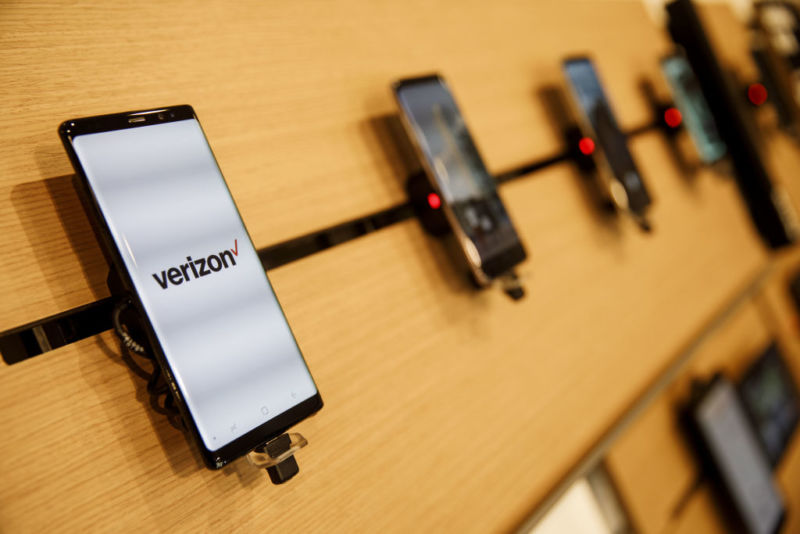 A Samsung Galaxy Note 8 smartphone with a Verizon logo on the screen, displayed for sale at a Verizon store.