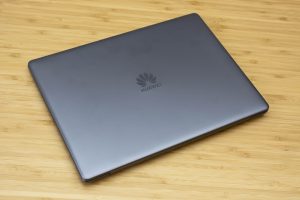 Huawei's Matebook 13 ultrabook sitting on a wooden table.