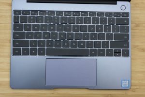 Huawei's Matebook 13 ultrabook sitting on a wooden table.