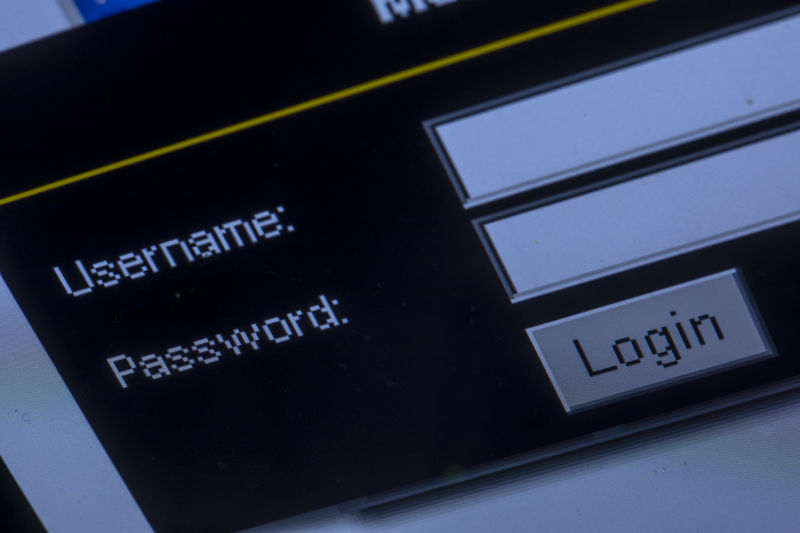 The query window for username and password on a Web page can be seen on the monitor of a laptop.