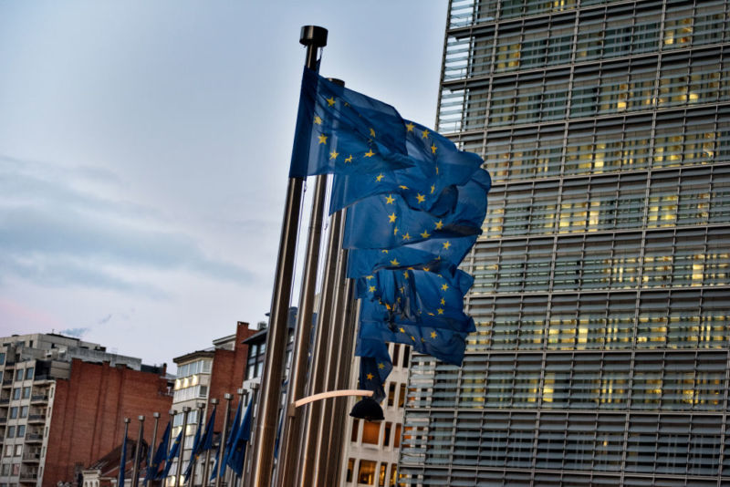 European flags wave in front of the Berlaymont building—the European Commission (EC) headquarter—in Brussels, Belgium. EC commissioners have cited a lack of progress by Google, Facebook, and Twitter on measures to stop disinformation operations associated with European elections.