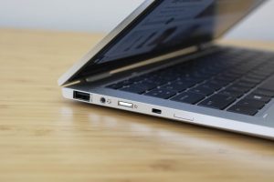 The HP Elitebook x360 1040 G5 sitting on a wooden table.