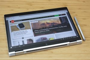 The HP Elitebook x360 1040 G5 sitting on a wooden table.