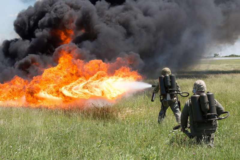 Marines use flamethrower to spectacular effect in field.