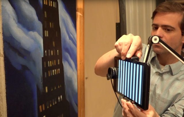 Oliver Cossairt sets up his portable "Tricorder" 3D-imaging apparatus in front of Georgia O'Keeffe's <em>Ritz Tower</em>.