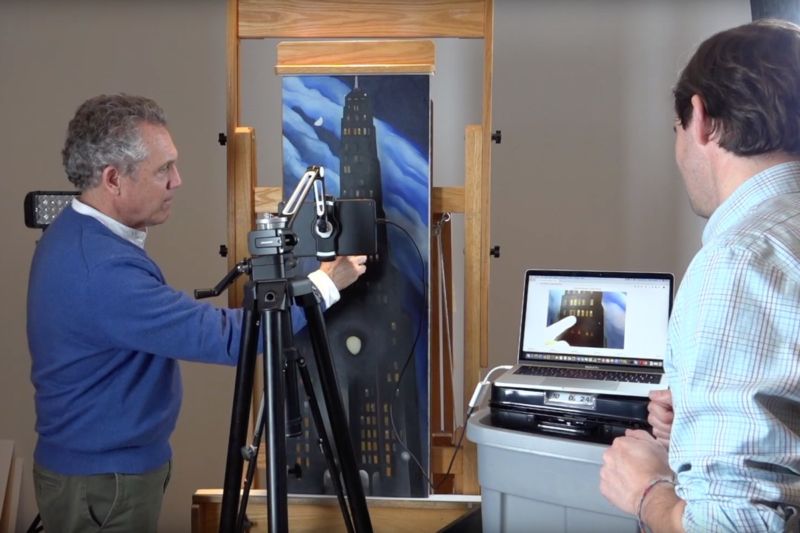 Dale Kronkright (left), head of conservation at the Georgia O'Keeffe Museum in Santa Fe, uses a handy new imaging tool to study "acne" on O'Keeffe's <em>Ritz Tower.</em> Northwestern University's Oliver Cossairt (right) developed the tool.
