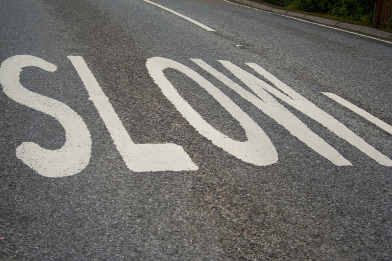 The word SLOW has been painted on a street for the benefit of drivers.