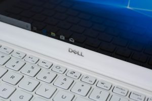 The Dell logo underneath the Dell XPS 13 laptop's display panel.