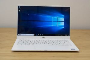 The Dell XPS 13 laptop sitting on a wooden table.