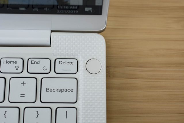 The power button with an embedded fingerprint sensor on the Dell XPS 13 laptop.