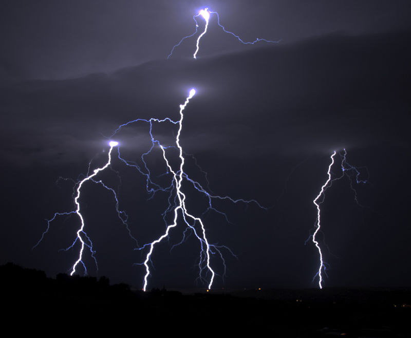 Lightning strikes through a cloud.