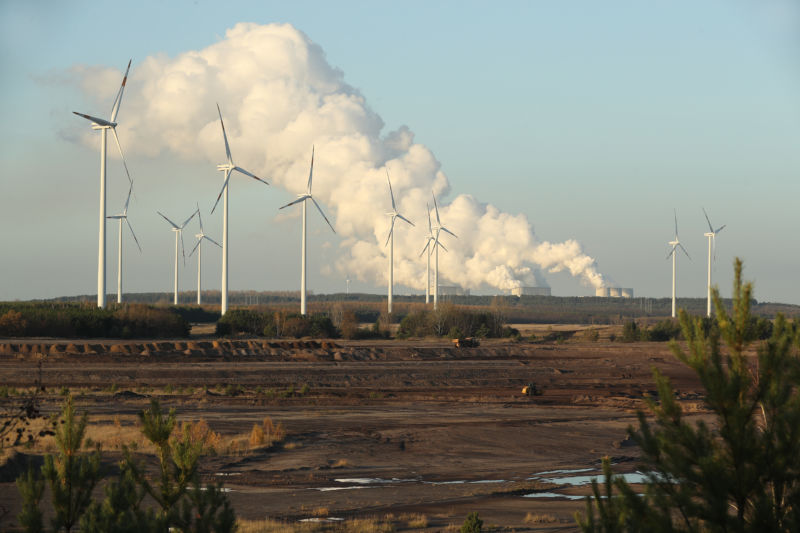 Wind turbines near a coal power station.