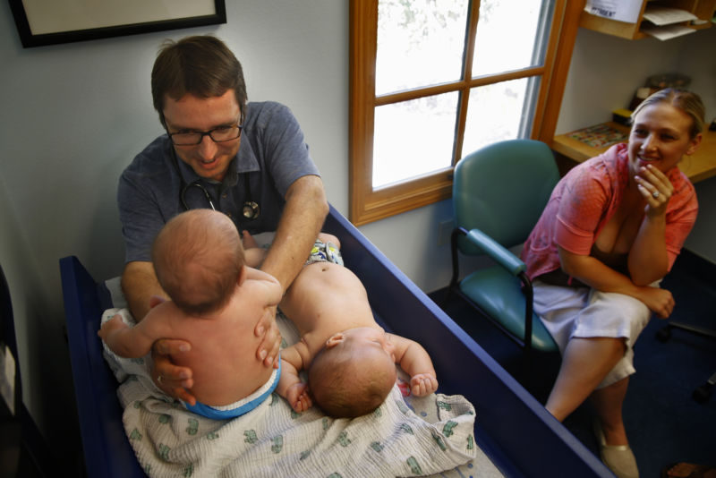 Dr. Robert Sears examines 2-mo-old twins. Sears is among the doctors who have been found to have issued fraudulent medical vaccination exemptions. 